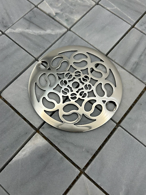 Round drain in Polished stainless steel finish.