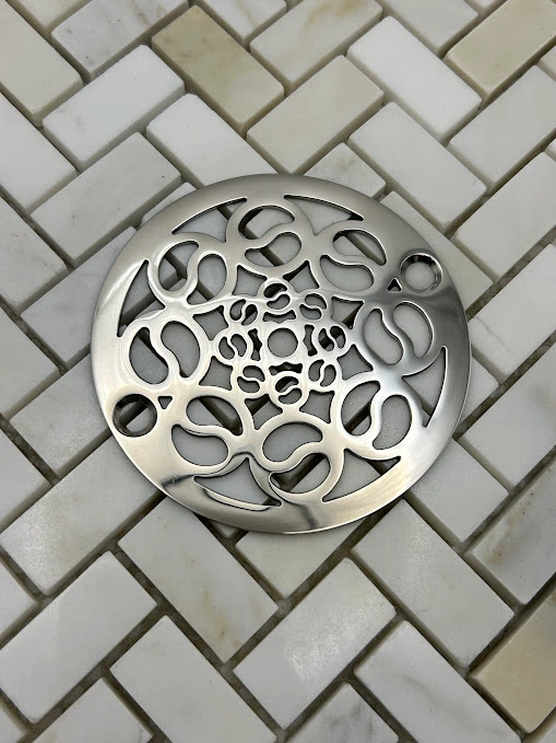 Round drain in Polished stainless steel finish.