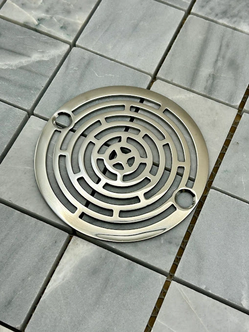 Round drain in Polished stainless steel finish.