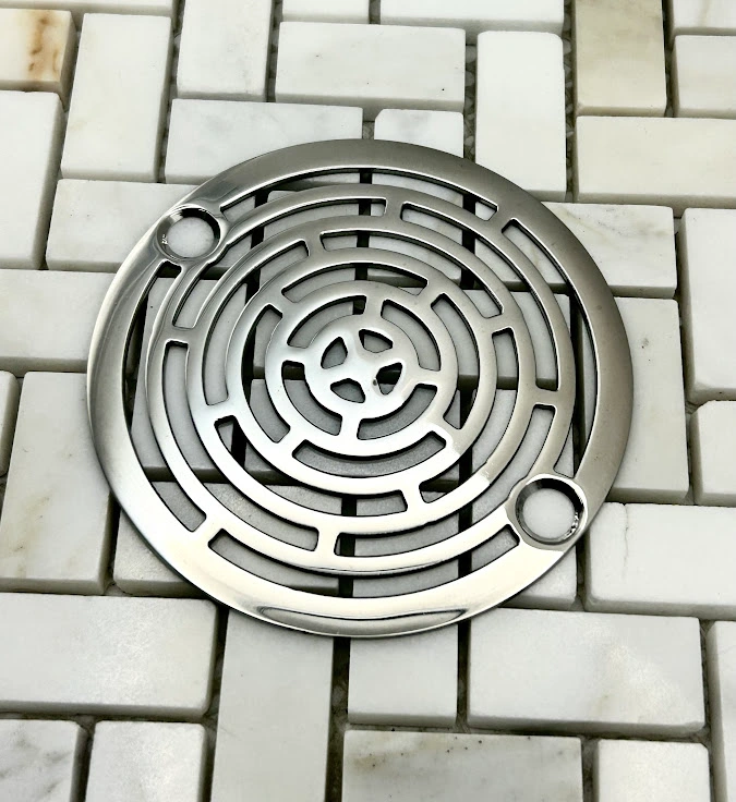 Round drain in Polished stainless steel finish.