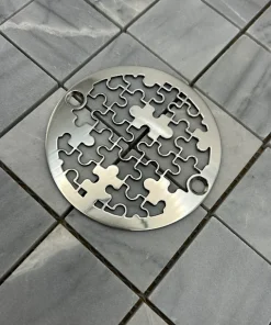 Round drain in Polished stainless steel finish.