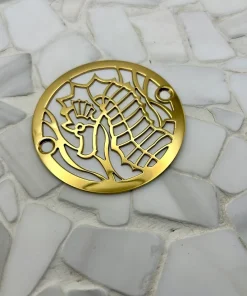 Round drain with seahorse design in polished brass finish.