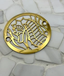 Round drain with seahorse design in polished brass finish.