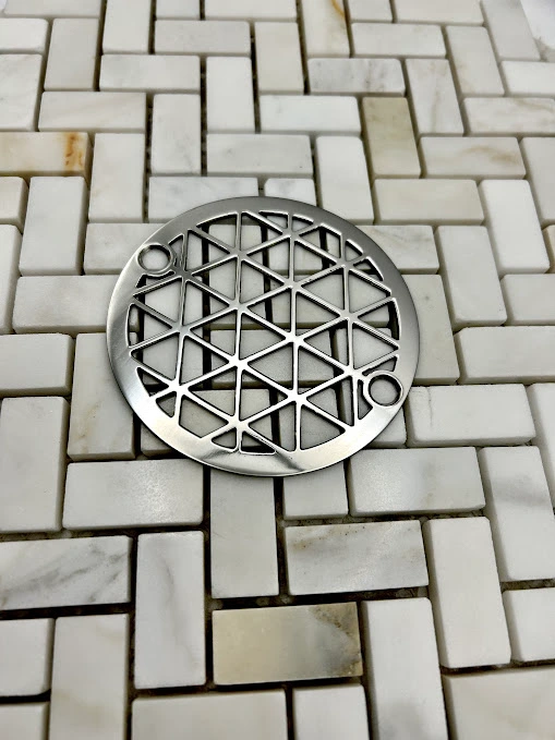 Round drain in Polished stainless steel finish.
