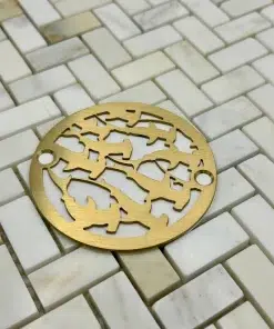 Round drain in a brushed brass finish.