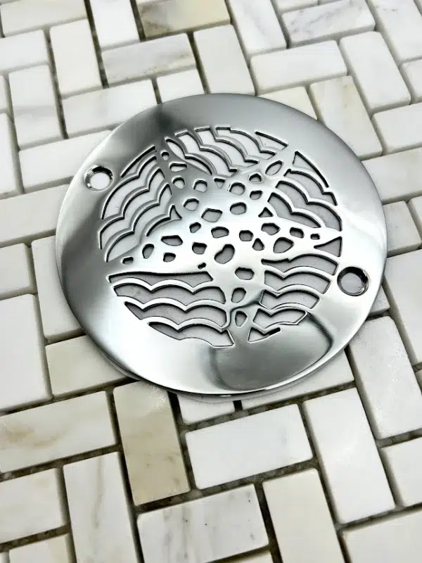 4 in round starfish polished stainless steel in off white tile