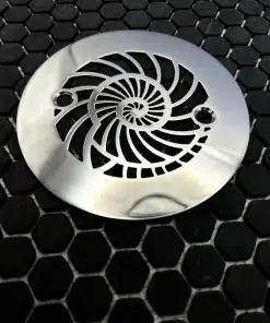 Round drain with nautilus design in polished stainless steel finish.