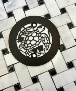 Round drain with turtle design in oil rubbed bronze finish.