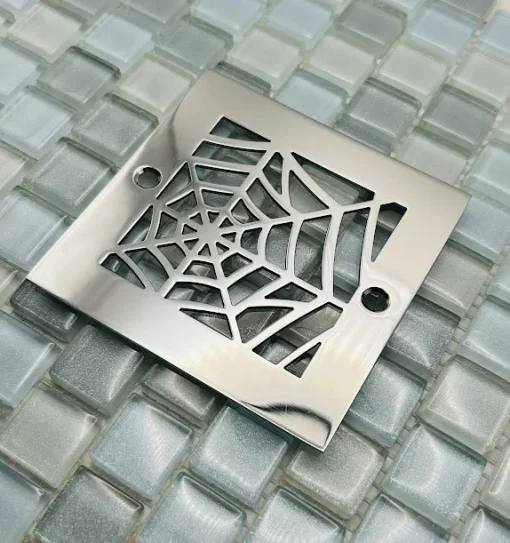 Square drain with polished stainless steel finish.
