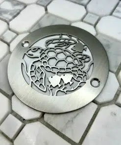 4in round Turtle design in Brushed Stainless Steel on white tile