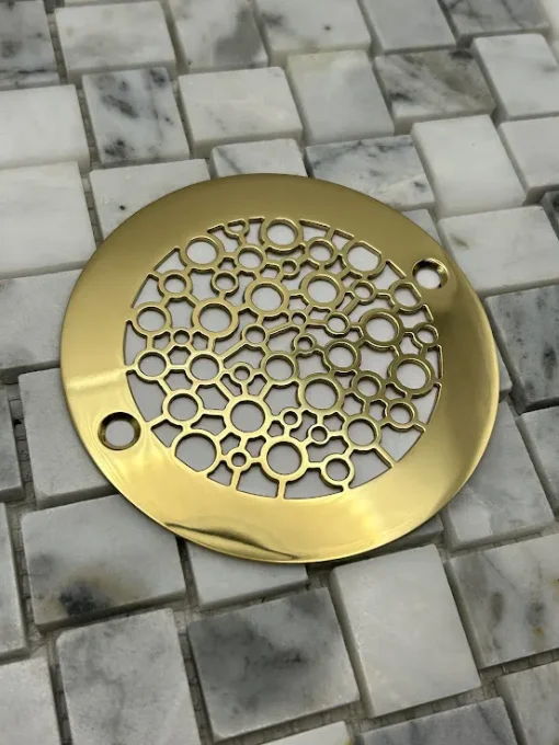 Round drain in a polished brass finish.