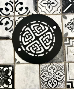 Round drain with Celtic design in matte black finish.