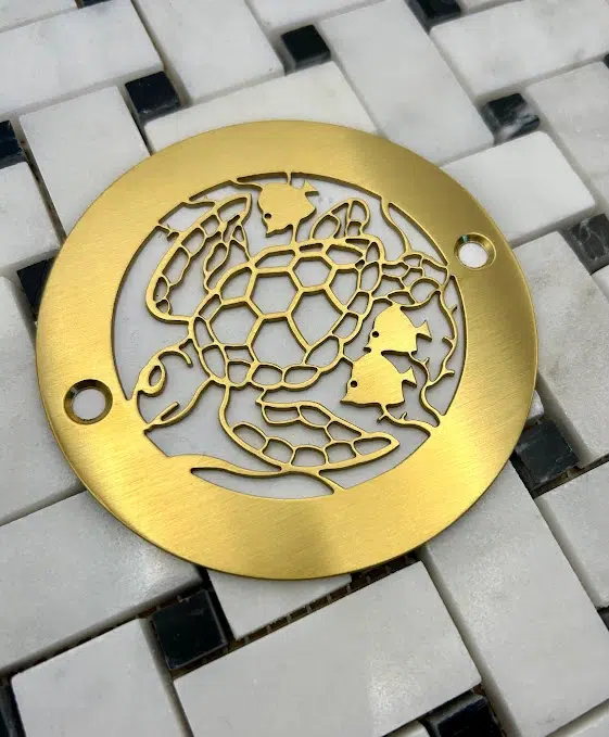 Round Drain in Brushed Brass Finish.