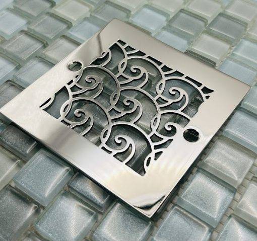 Square drain with polished stainless steel finish.