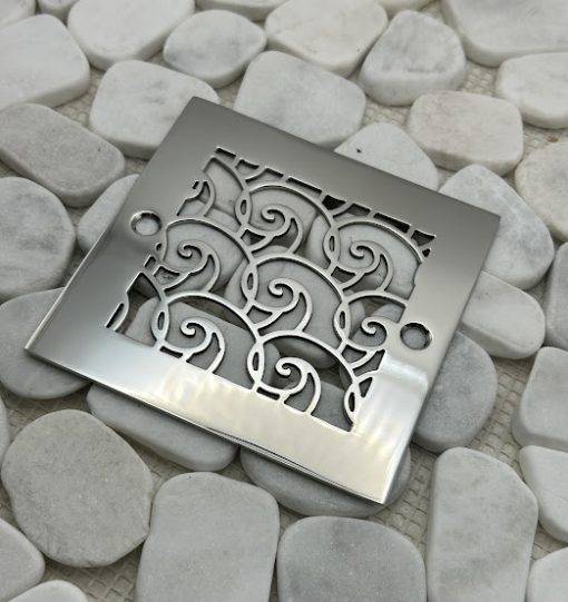 Square drain with polished stainless steel finish.