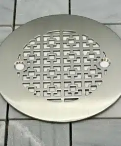 Geometric No. 1 4.25 round shower drain in brushed stainless steel on tile