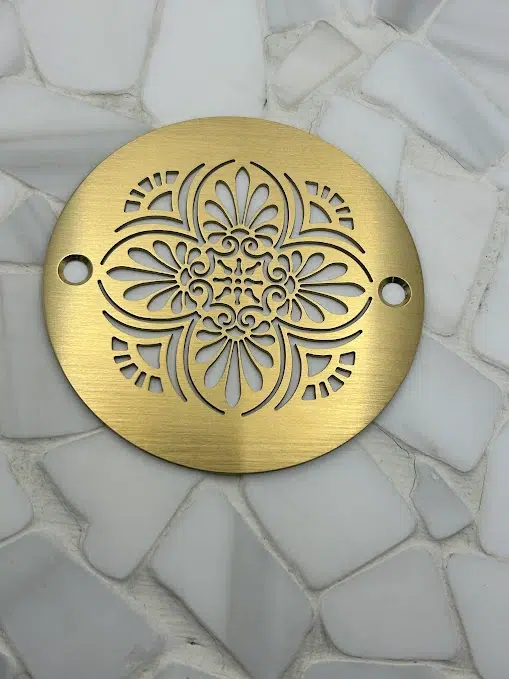 Round drain in a Brushed Brass finish.