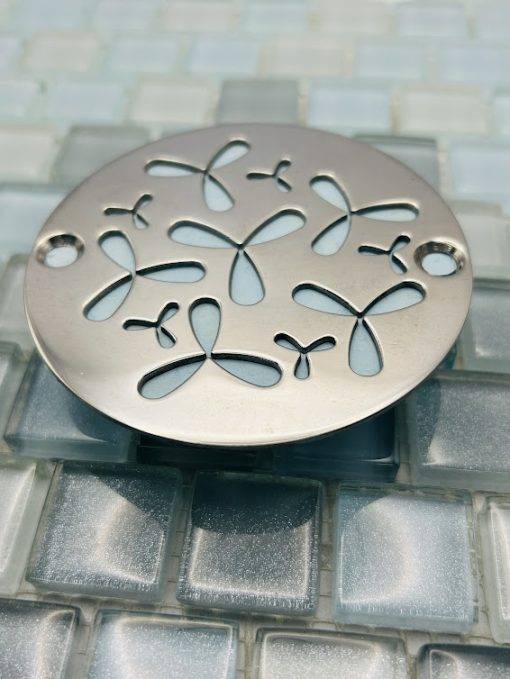 Round drain with polished stainess steel finish.