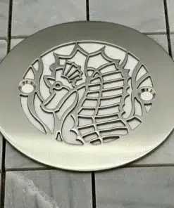 Seahorse 4.25 round shower drain cover in brushed stainless steel on tile