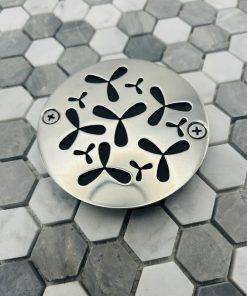 Round drain with polished stainless steel finish.