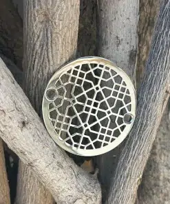 Round drain in polished stainless steel finish.