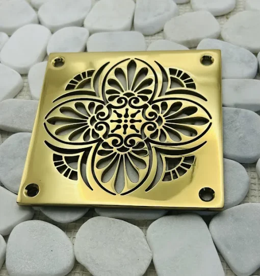 Square drain with polished brass finish.