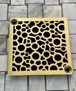 Bubbles Schluter brushed brass on tile