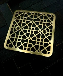 Square drain with polished brass finish.