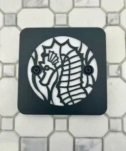 Square Kohler drain with a matte black finish.