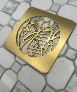 Square drain with brushed brass finish.