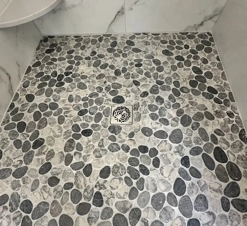 Octopus Schluter drain installation brushed stainless steel by Designer Drains