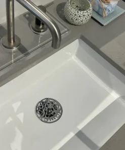 Round sink stopper with polished stainless steel finish.
