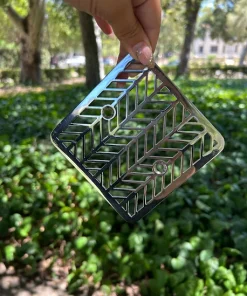Square drain with polished stainless steel finish.