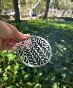 Round drain with polished stainless steel finish.