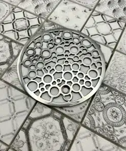 Round drain in polished stainless steel finish.