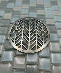 Round drain with polished stainless steel finish.