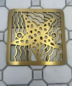 Square drain in brushed brass finish.