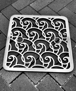 Square drain with polished stainless steel finish.