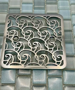 Square drain with polished stainless steel finish.