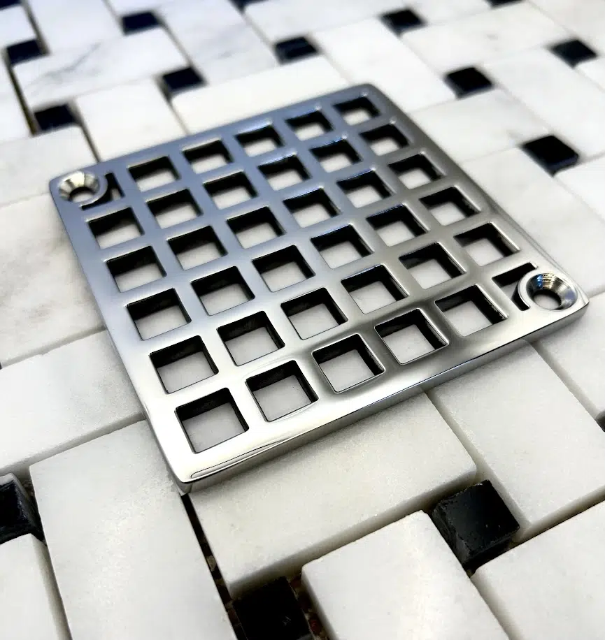 Square drain with Geometric squares 7 design in polished stainless steel finish.