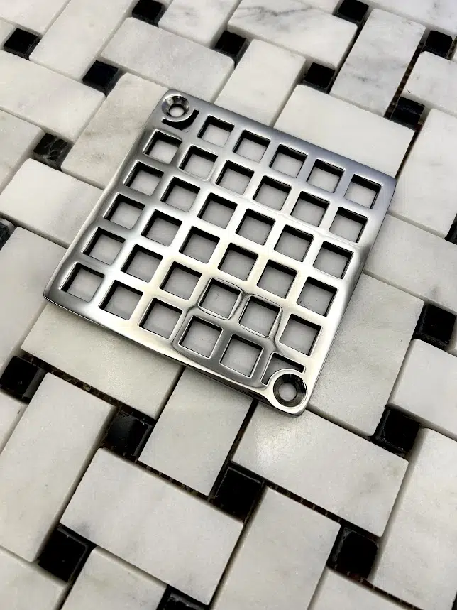 Square drain with Geometric squares 7 design in polished stainless steel finish.