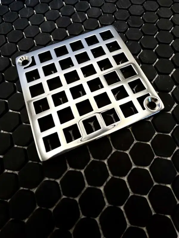Square drain with Geometric squares 7 design in polished stainless steel finish.