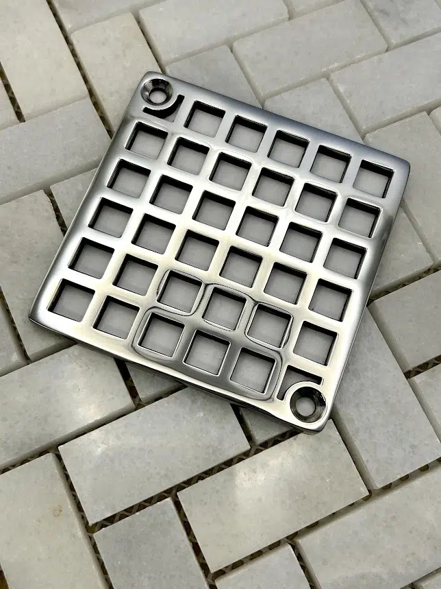 Square drain with Geometric squares 7 design in polished stainless steel finish.
