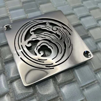 Square drain with polished stainless steel finish.