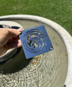 Square drain with polished stainless steel finish.