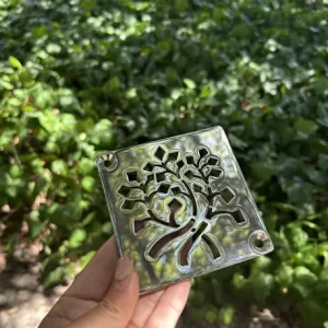 Square drain with polished stainless steel finish.