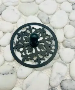 Round sink stopper in matte black finish.