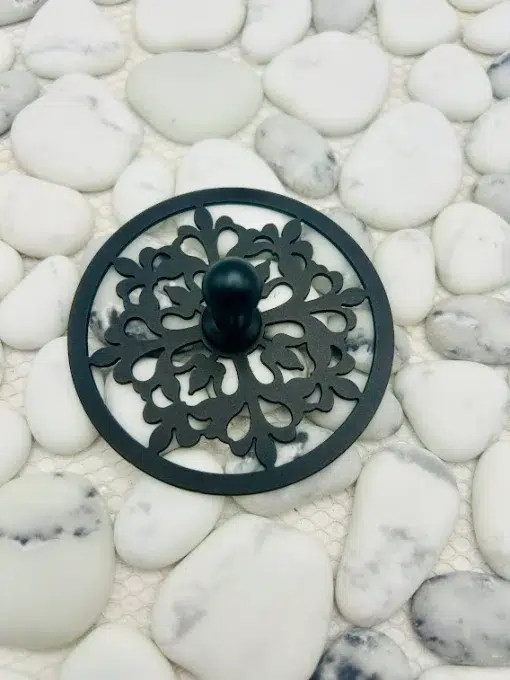 Round sink stopper in matte black finish.