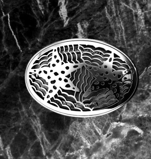 Starfish-Oval-Drain-Kin-installed-on-black-Marble-Designer-Drains