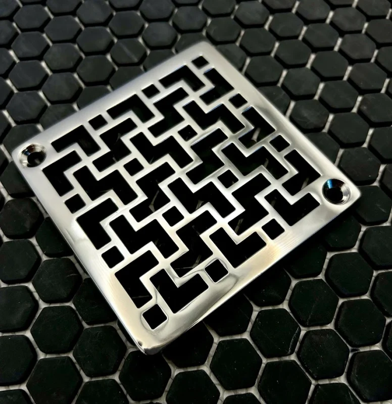 Square drain in tulun design with polished stainless steel finish.